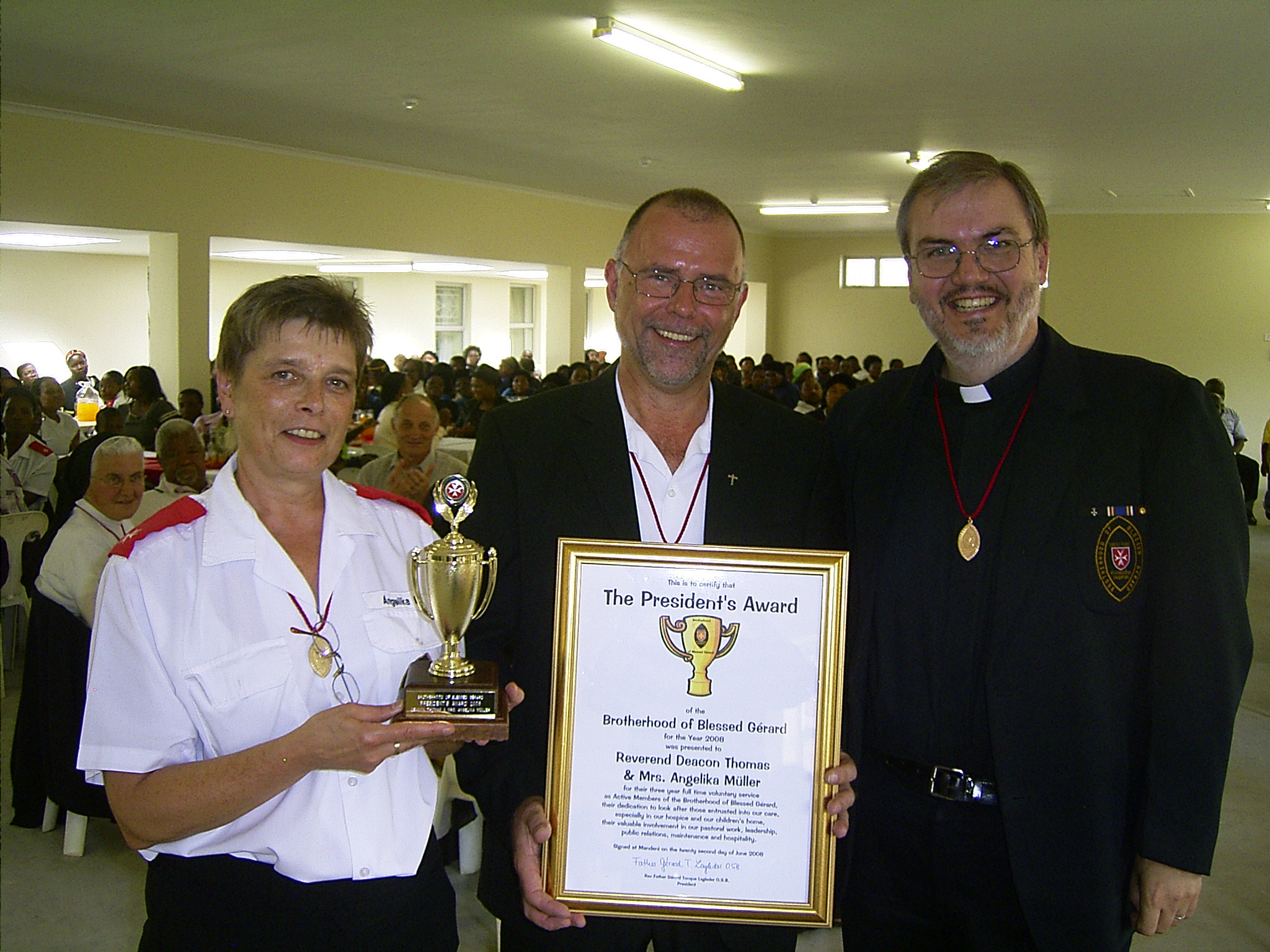 Angelika Müller and Deacon Thomas Müller with the joint President’s Award trophy and certificate, beside Father Gérard, on 22 June 2008