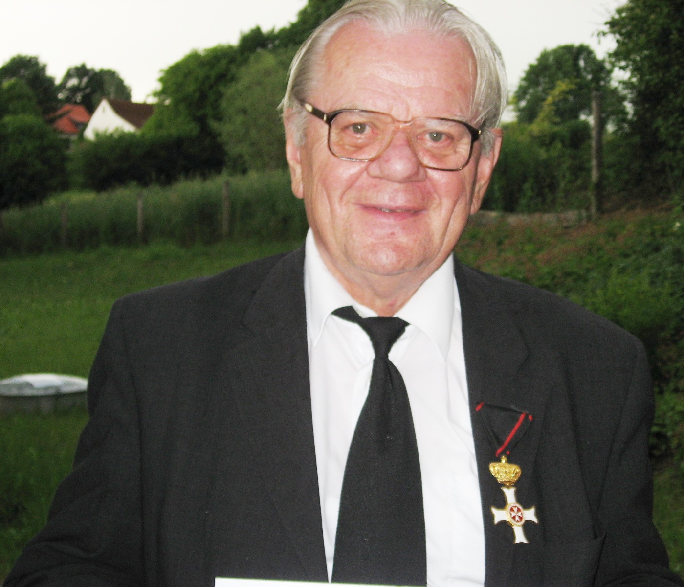 Father Georg Weinzierl wearing the Cross pro piis meritis